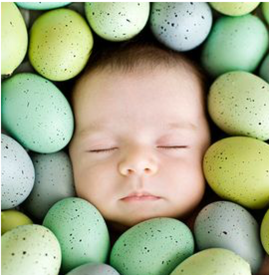 baby with head surrounded by eggs